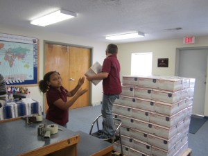 Stacking boxes of Bibles for shipment.